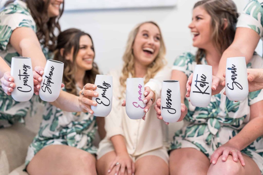 bride and bridesmaids holding custom champagne tumblers