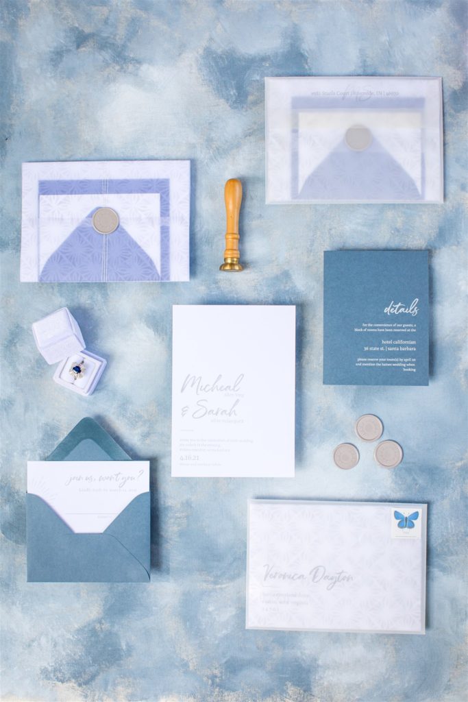 light pastel blue wedding invitations with wedding ring and stamps for Hartley Botanica styled shoot