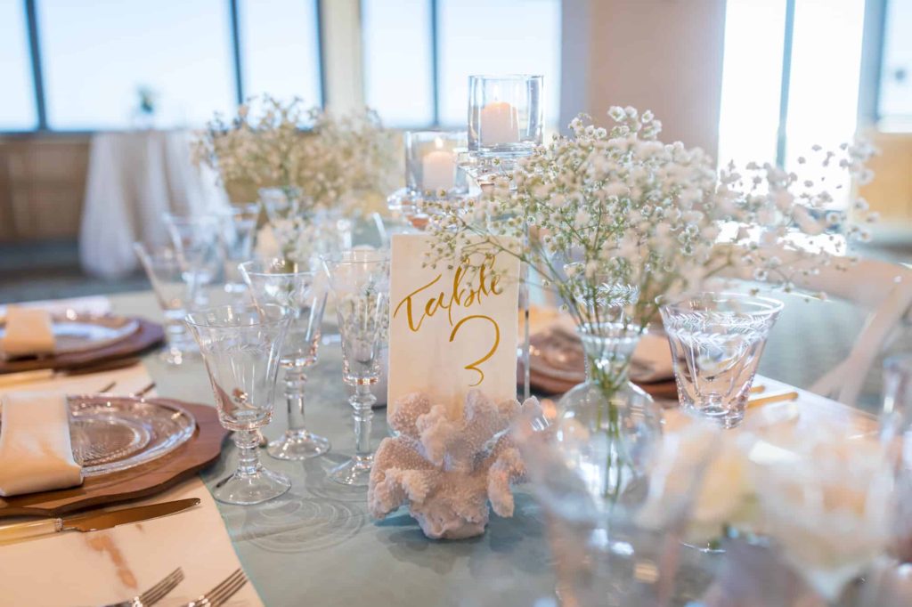 wedding reception table with babies breathe and crystal glasses at Cabrillo Pavilion