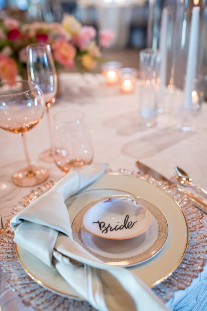 custom calligraphy table decor with a shell that reads "bride"