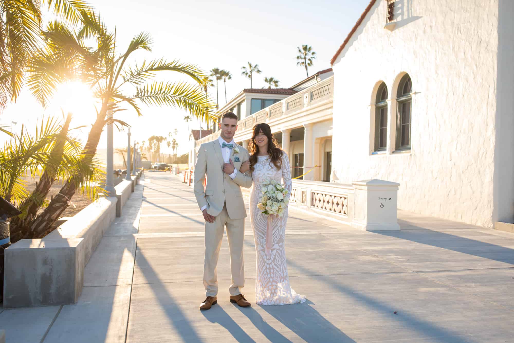 bride and groom sunset portraits on Santa Barbara boardwalk