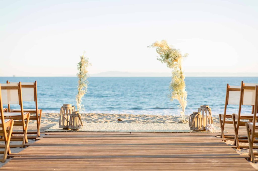 beach ceremony with wood lanterns and tall pompous grass