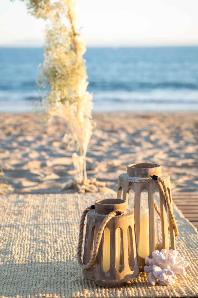 detail shot of wood lanterns at the ceremony space with a jute rug