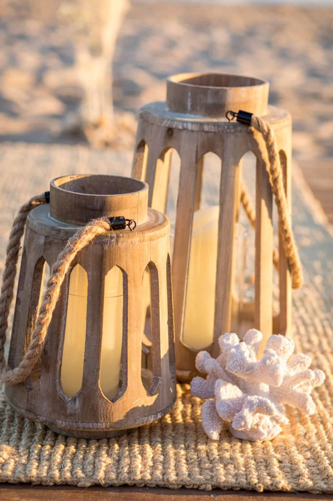 beach ceremony decor with wood lanterns and shells
