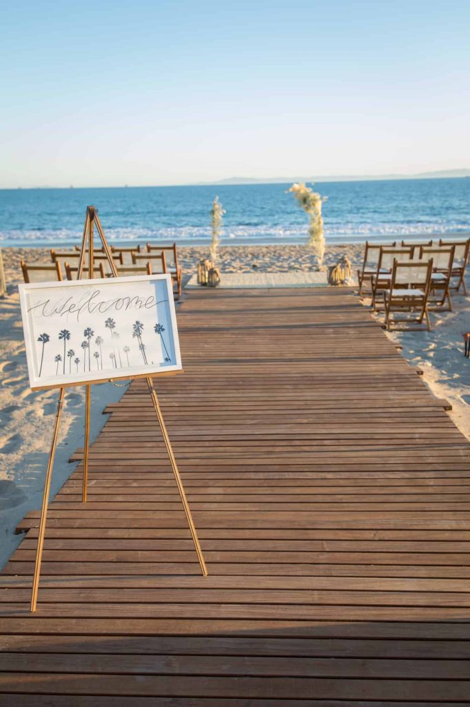 welcome sign at the front of a beach wedding ceremony location