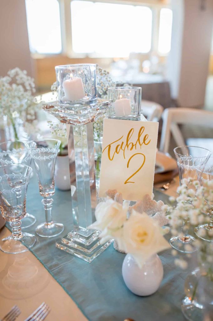 elegant gold table number for beach wedding reception indoors at Cabrillo Pavilion