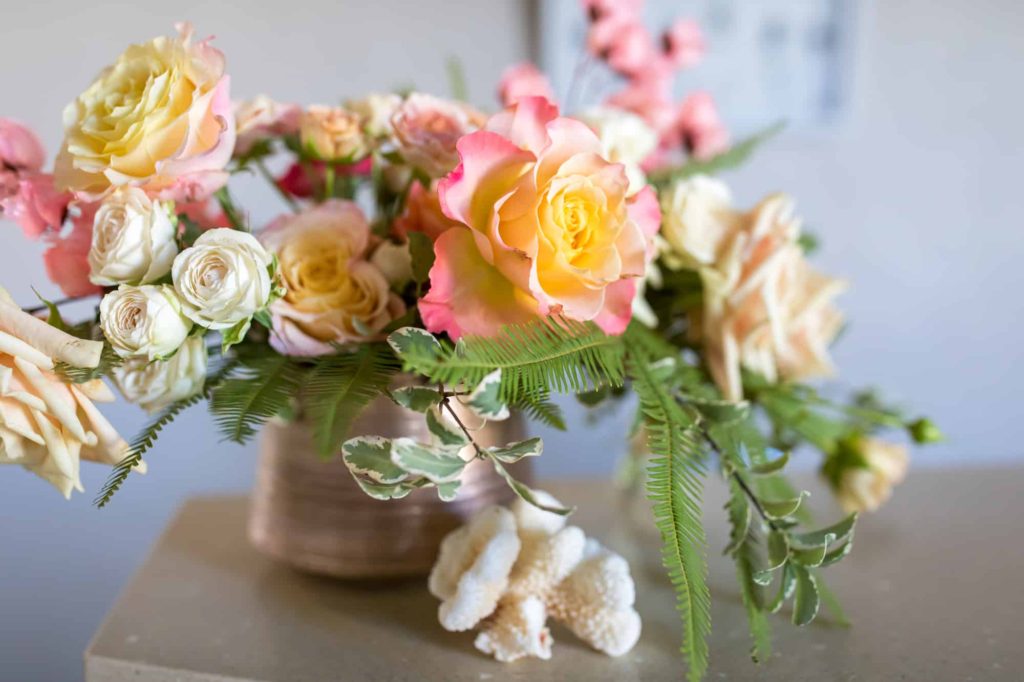 summer bridal florals with yellow and pink roses with whimsical greenery