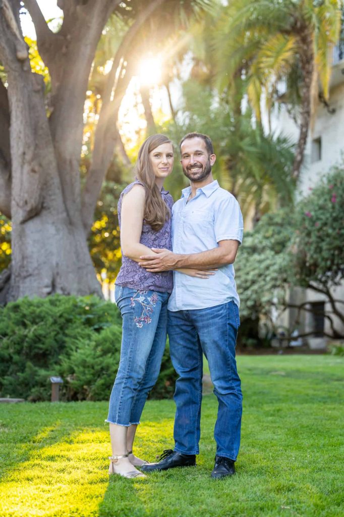 Santa Barbara engagement photos with sunsetiing in the background as the man and woman embrace each other