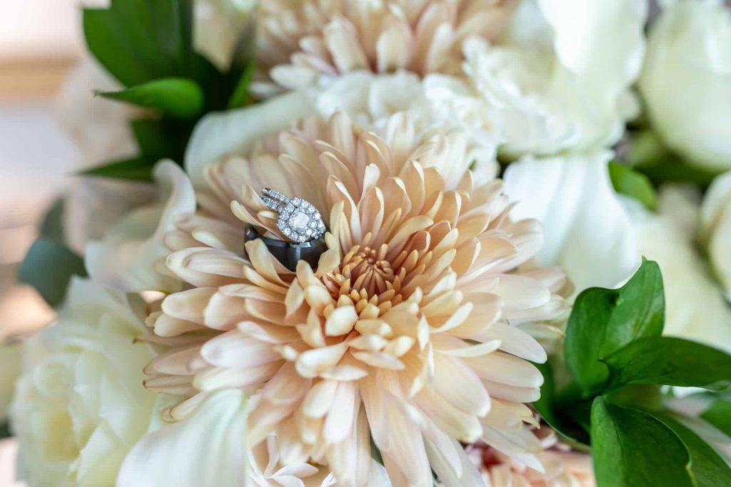 engagement ring on ivory and white flowers