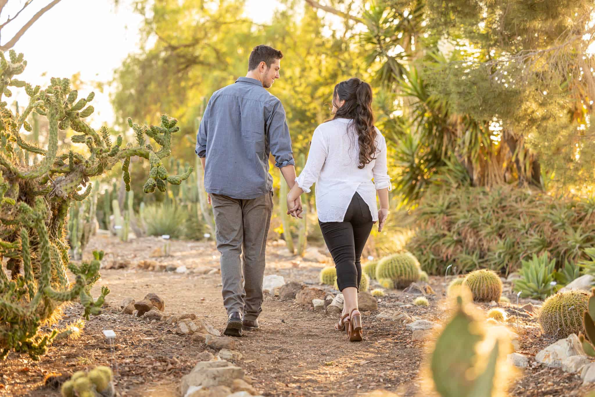 Conejo Botanical Gardens engagement photos by Thousand Oaks wedding photographer with man and woman holding hands and walking through the desert