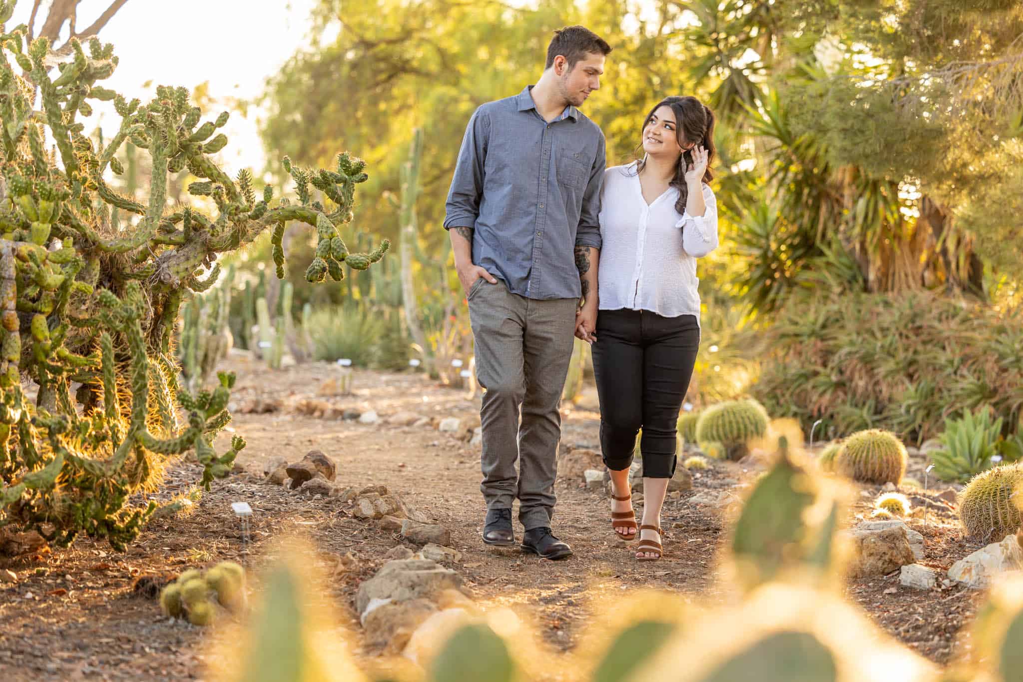 mand and woman hold hands in the desert for their engagement photos with Thousand Oaks wedding photographer