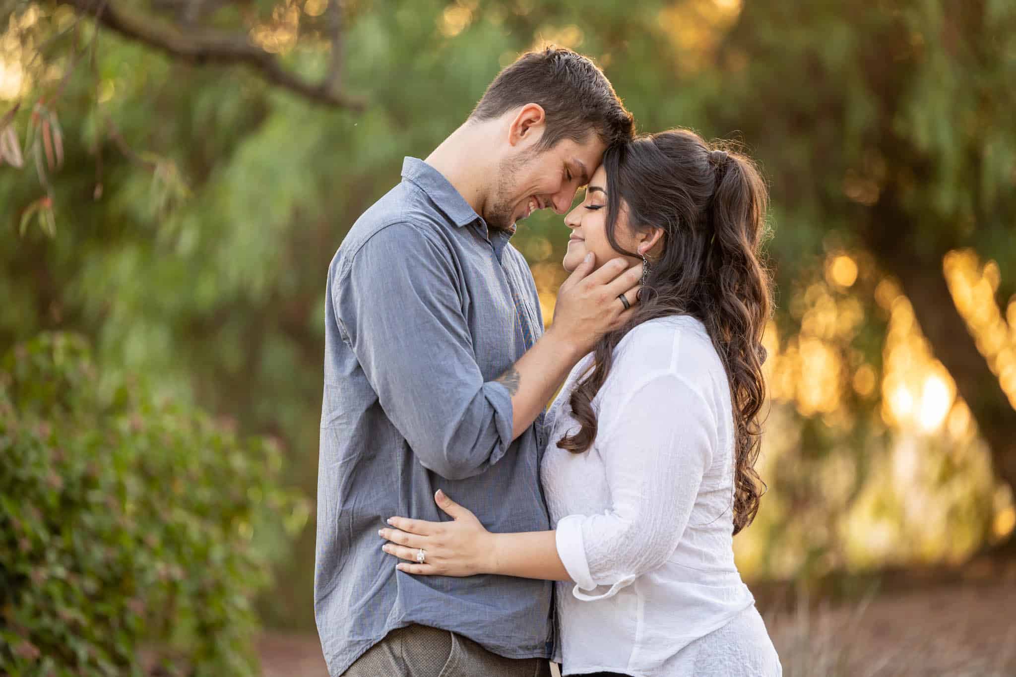 Thousand Oaks wedding photographer captures man and woman embracing as the man holds the womans face
