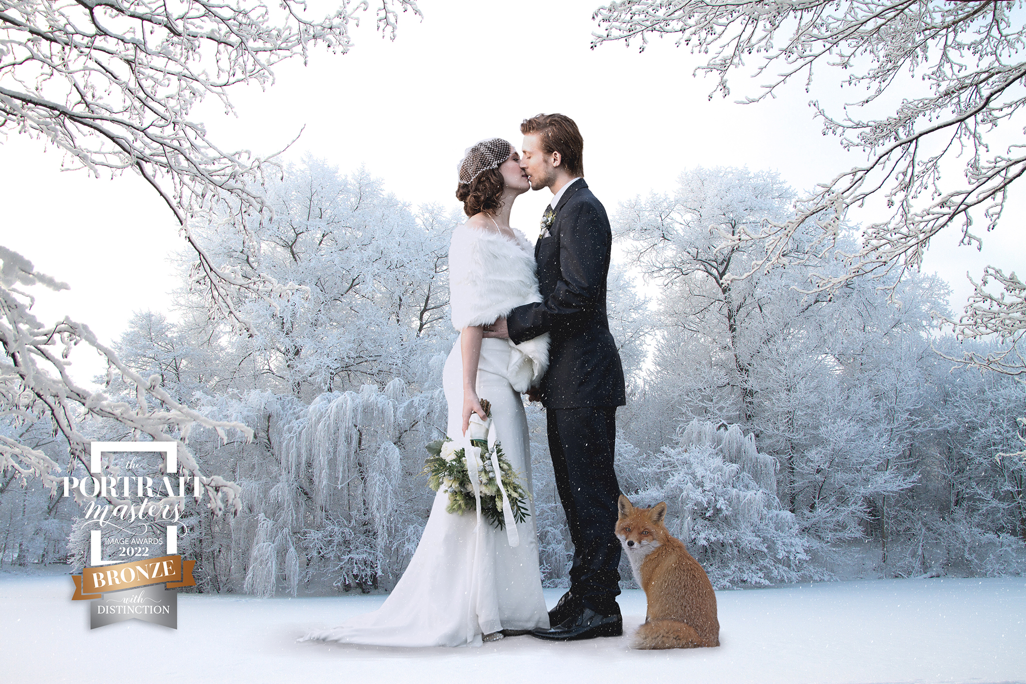 bronze award wedding couple standing in the snow with a fox sitting next to them