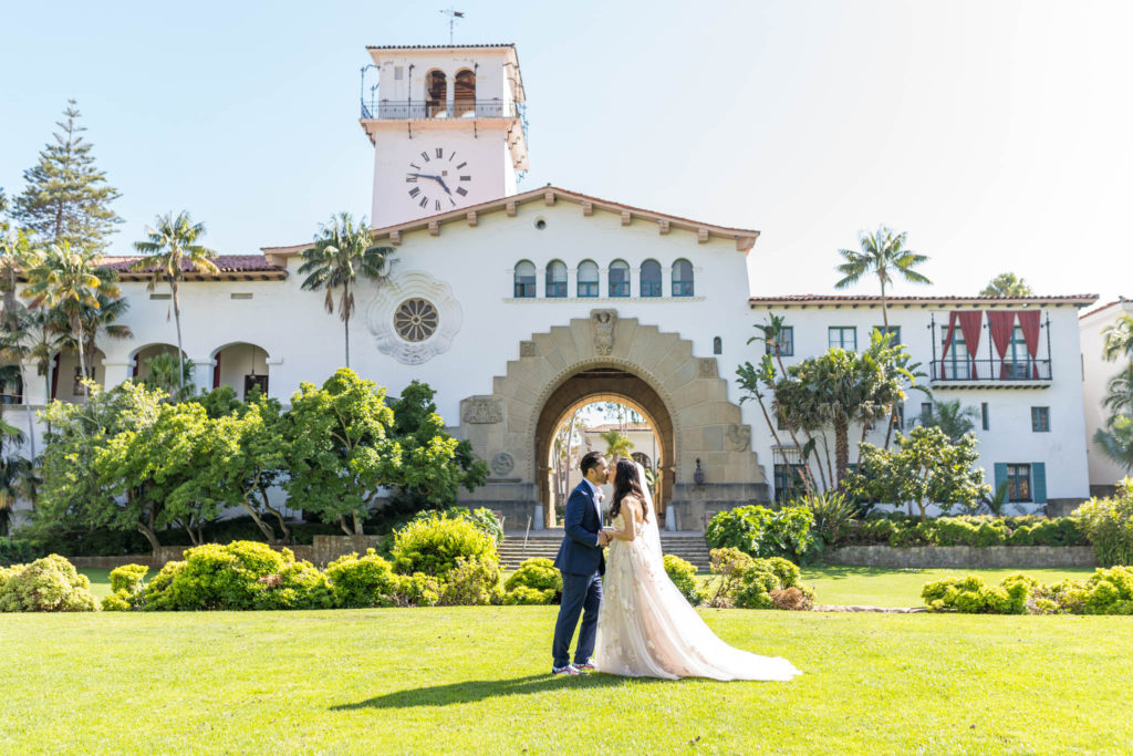 wedding couple standing in front of the santa barbara courthouse
