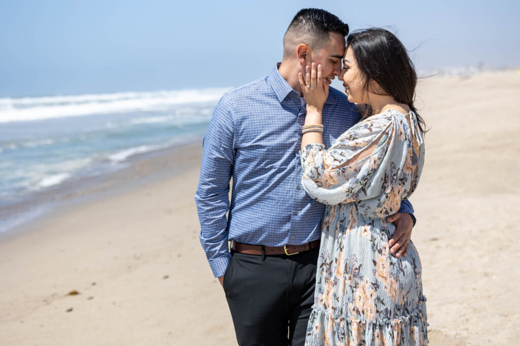 newly engaged couple together on ventura beach during their proposal photography session