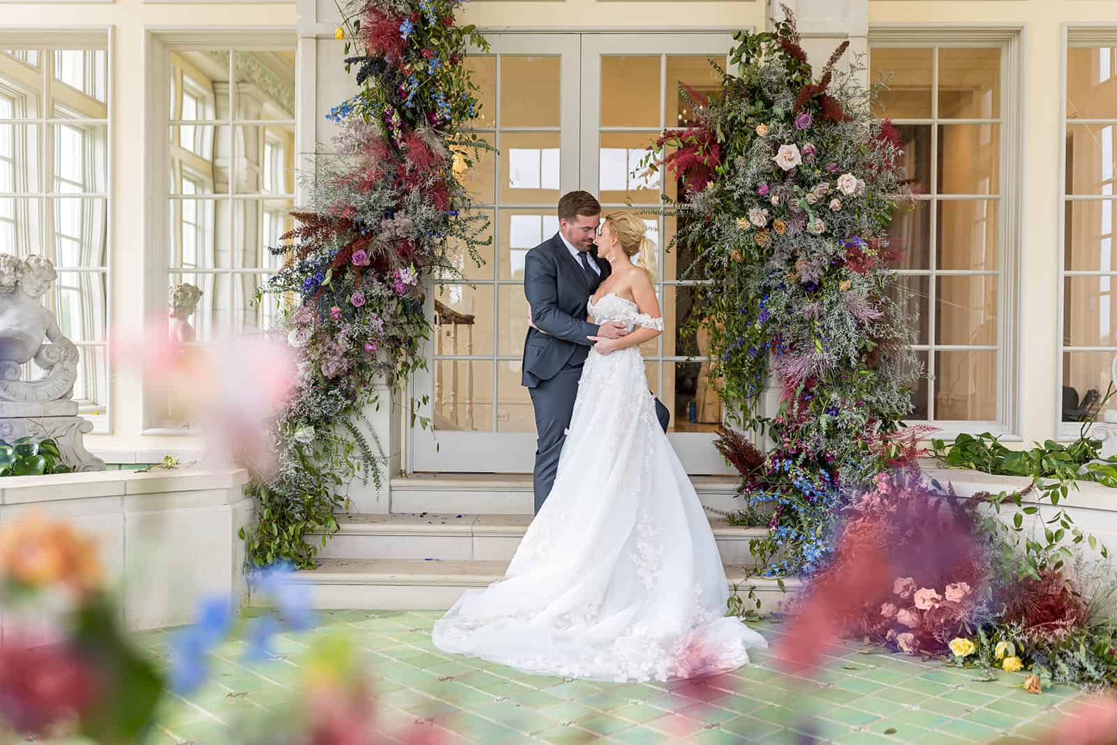 couple standing by floral covered doorsteps at ojai valley inn