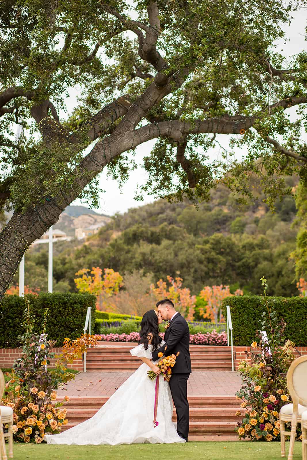 bride and groom kissing at their outdoor sherwood country club wedding