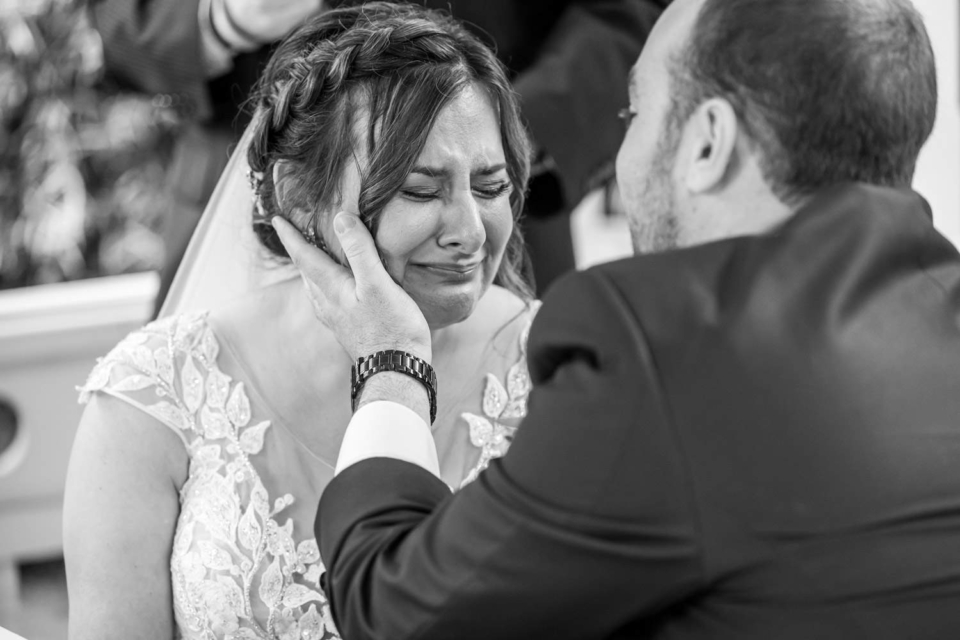 groom holding brides face as she cries during their camarillo wedding