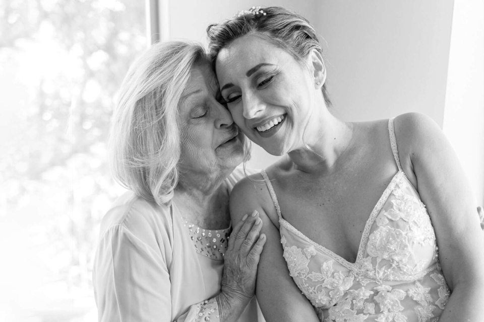 Mother hugging her daughter on the brides wedding day at the Ojai Valley inn by santa barbara wedding photographer
