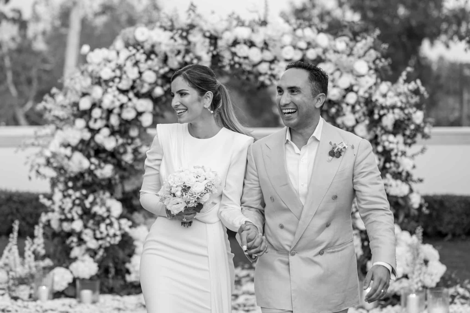 Happy bride and groom walking down the aisle at their Rosewood Miramar wedding in Santa Barbara