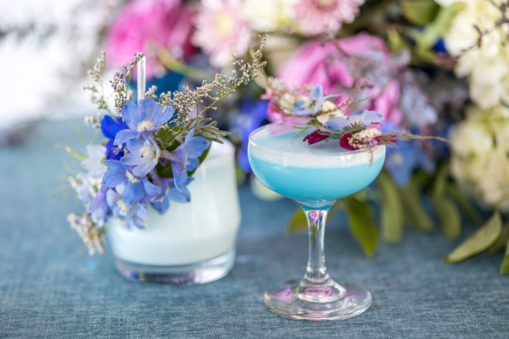 Elegant blue cocktails with edible flowers