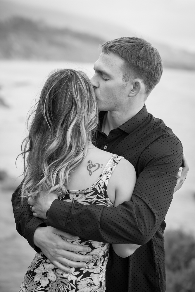 man kissing woman engagement session carpinteria bluffs