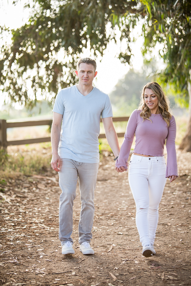 couple holding hands walking engagement session carpinteria bluffs