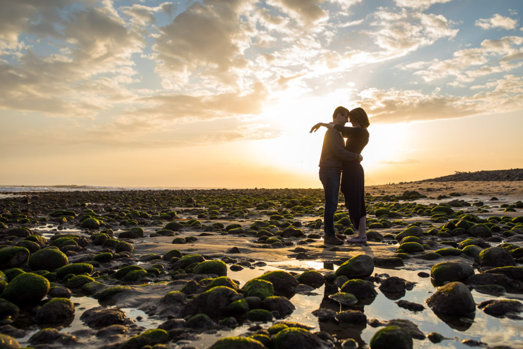 couple's silhouette surfers point engagement session