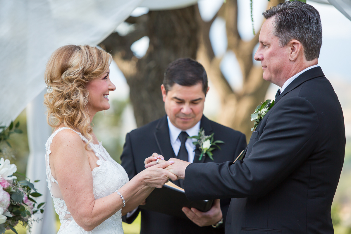 bride and groom exchanging rings Spanish hills country club wedding